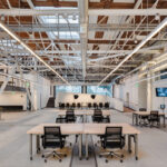 Weldmarx sit-to-stand desks in open office