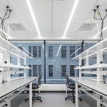 Open biotechnology laboratory with FLX island workstations and laboratory casework