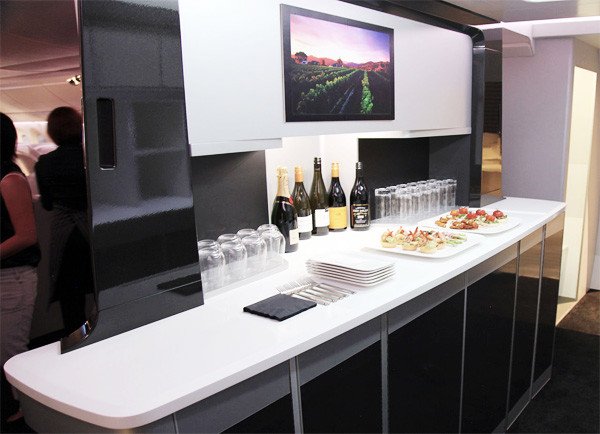 Many business travelers consider airplanes to be an extension of their office. A distinctive design element on Air New Zealand's new fleet of all-black Boeing 787-900s is the passenger cocktail bar. Its sleek black panels, separated by aluminum frames, are in keeping with the International Style. Many business travelers consider airplanes to be an extension of their office. A distinctive design element on Air New Zealand's new fleet of all-black Boeing 787-900s is the passenger cocktail bar. Its sleek black panels, separated by aluminum frames, are in keeping with the International Style.